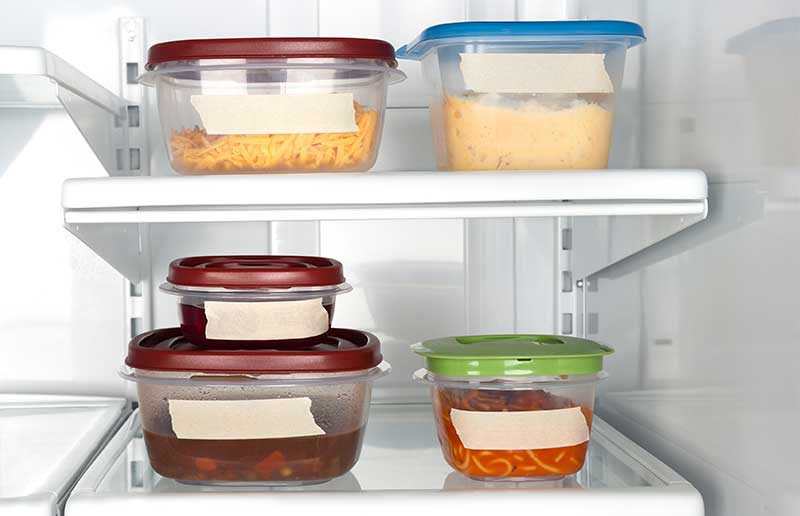 containers filled with leftovers in the fridge