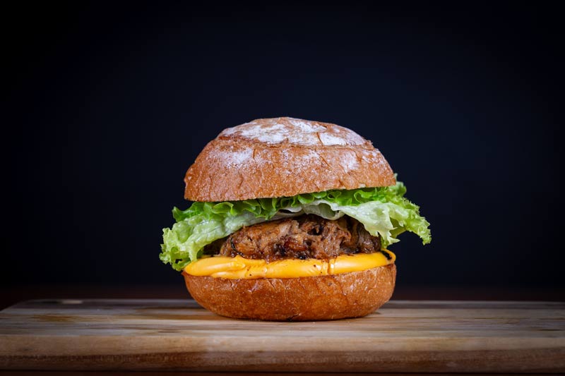 Cheeseburger sitting on a countertop.
